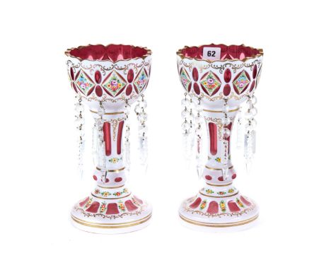 A PAIR OF 20TH CENTURY BOHEMIAN RUBY AND WHITE OVERLAY LUSTRES with panels of floral decoration, each hung with eight buttons