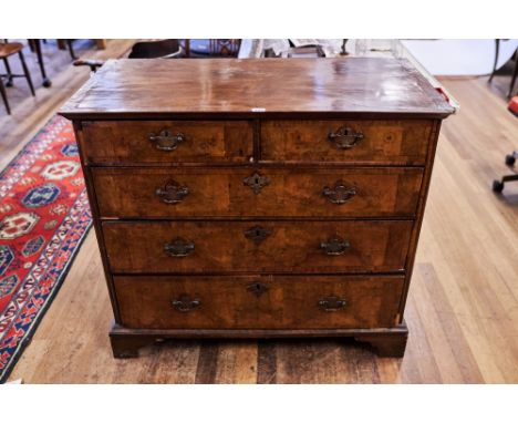 AN EARLY 18TH CENTURY WALNUT VENEERED CHEST OF DRAWERS, the moulded edge top above two short and three long drawers, oak line