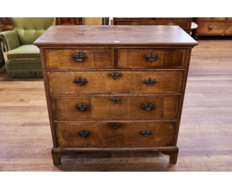 AN 18TH CENTURY OAK AND WALNUT VENEERED CHEST OF DRAWERS, two short and three long drawers, on bracket feet, 39 ins wide.   £