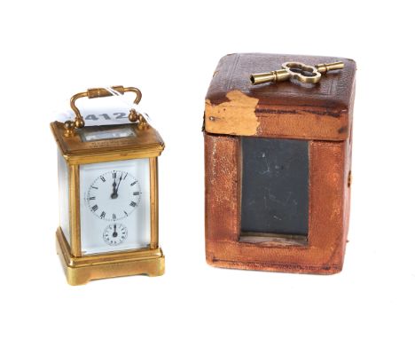 AN EARLY 20TH CENTURY FRENCH MINIATURE BRASS 8 DAY CARRIAGE CLOCK with alarm, 3 ins high together with carrying case and key.