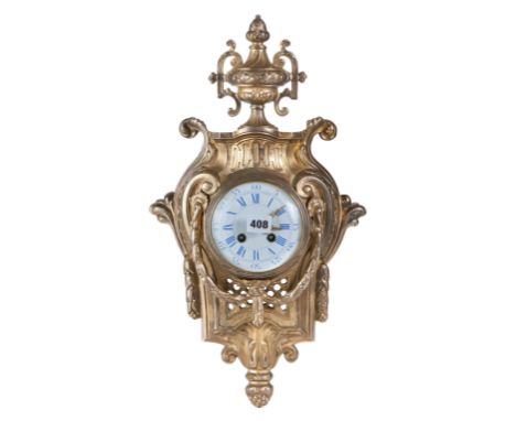 A LATE 19TH CENTURY GILT BRASS CARTEL WALL CLOCK, white enamel dial with twin train Japy Freres movement, the rococo case sur