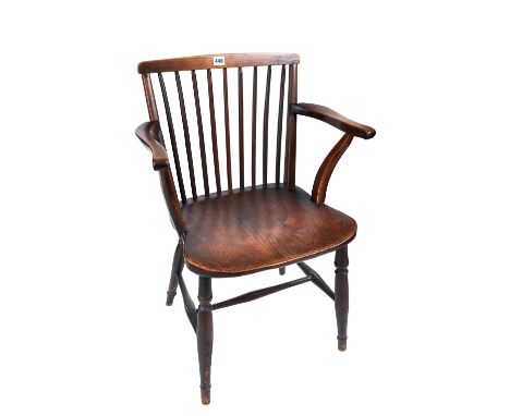 A 19TH CENTURY COUNTRY MADE BEECHWOOD AND ELM STICK BACK ELBOW CHAIR with solid saddle seat raised on turned legs united by s