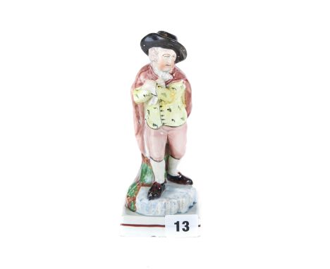 AN 18TH CENTURY ENGLISH POTTERY WOOD TYPE FIGURE of a male ice skater wearing a brown cloak, raised on a square base, 7 3/4 i