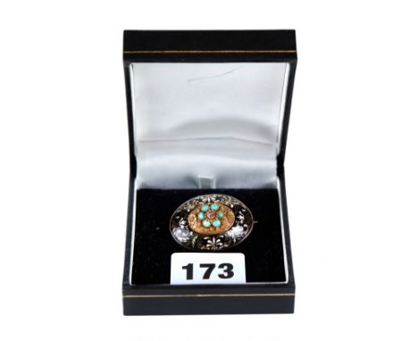 A GOOD QUALITY ANTIQUE OVAL YELLOW GOLD BROOCH with ruby and turquoise centre panel and foliate enamelled border, tests as 14