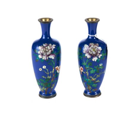 A PAIR OF EARLY 20TH CENTURY JAPANESE CLOISONNE ENAMEL VASES, blue ground decorated with flowers, 7 ins high.   £40-£60