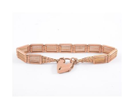 A rose metal gate link bracelet, 9mm five bars wide, fitted with a padlock fastener marked 9ct, approximate weight 17gms. 