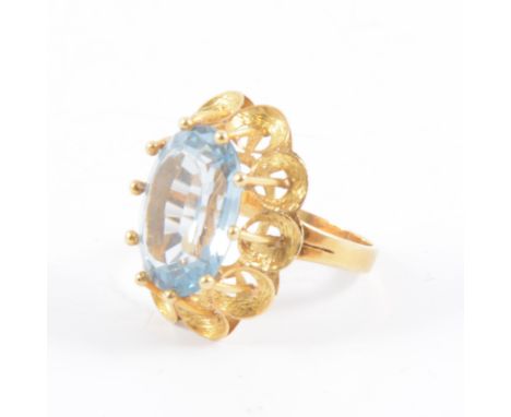 A synthetic blue spinel dress ring, the oval step cut stone, 15.8mm x 11.5mm, set with raised claws in an all yellow metal mo