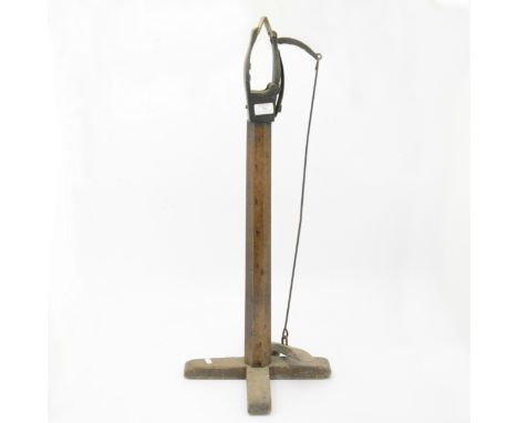 A free standing glove makers vice, wooden pillar.