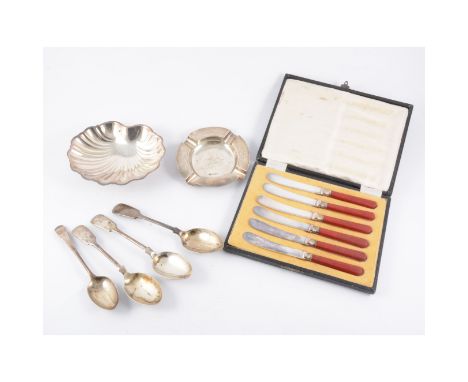 A silver ashtray, engine turned design, a silver shell butter dish, four silver dessertspoons and a cased set of teaknives, t