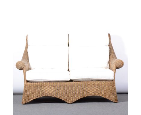 Rattan cane two seater sofa and armchair, with cream cushions, length 147cm, depth 94cm, height 99cm. (2)
