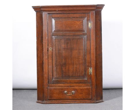 George III oak hanging corner cupboard, adapted, moulded cornice, two panel door over a single drawer, height 118cm.