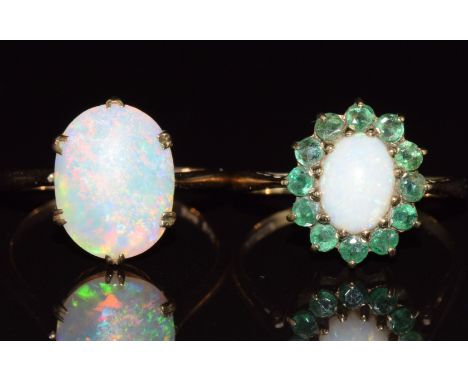 Two 9ct gold rings, one c1920 set with an opal cabochon and the other set with opal and emeralds, 4.6g, sizes L &amp; N