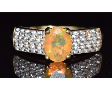 A 9ct gold ring set with an opal and topaz, 2.4g, size R