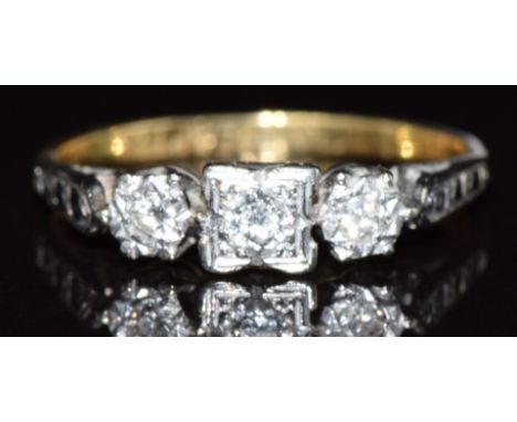 An 18ct gold ring set with three diamonds in a platinum setting, 2.3g, size K