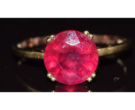 A 9ct gold ring set with a round cut ruby (fracture filled), 2.3g, size S