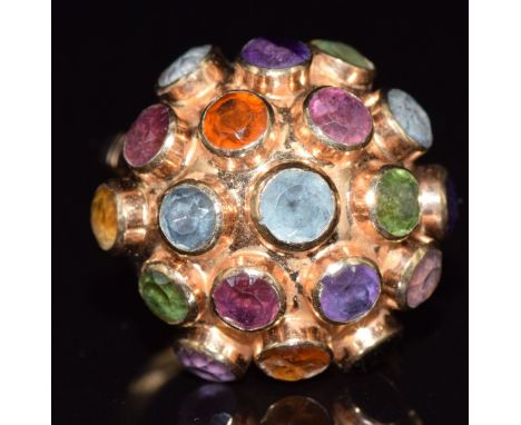 An 18ct gold ring set with tourmaline, peridot, amethyst and citrine in a domed cluster, 4.9g, size M