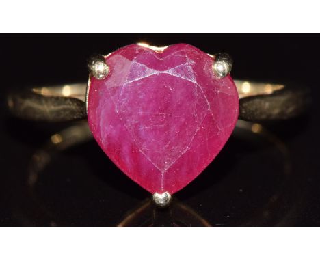 A 9ct gold ring set with a heart cut ruby, 2.8g, size N