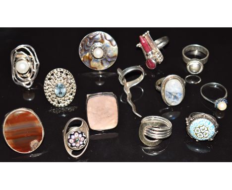 Thirteen silver rings including millefiori examples, one marked Finland, agate, abalone and pearl, pearl and sapphire, ruby, 