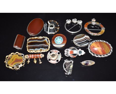 A collection of Victorian agate brooches including eight silver examples, a Celtic or penannular brooch with shamrock design,
