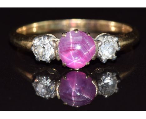 A 9ct gold ring set with a star ruby cabochon and two old cut diamonds, each approximately 0.2ct, 3.3g, size Q