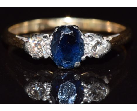 An 18ct gold ring set with a sapphire and diamonds, 3.5g, size R