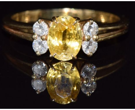 French&nbsp;18ct gold ring set with a yellow sapphire of approximately 0.65ct and four diamonds, 2.9g, size K