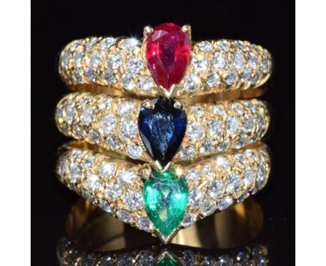 An 18ct gold ring set with a pear cut emerald, sapphire, and ruby, each approximately 0.7ct, the band set with diamonds, 13.2