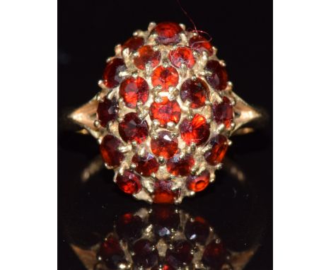 A 9ct gold ring set with garnets in a cluster, 2.9g, size K