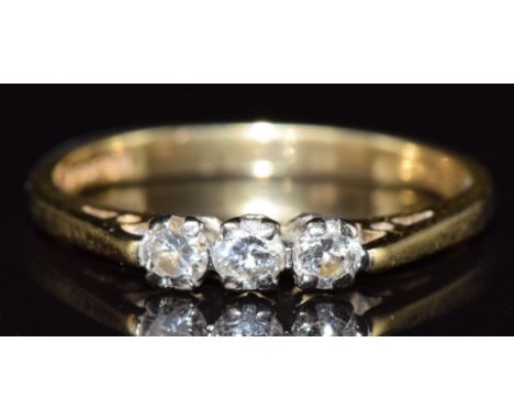 An 18ct gold ring set with three diamonds totalling approximately 0.25ct, 2.3g, size K