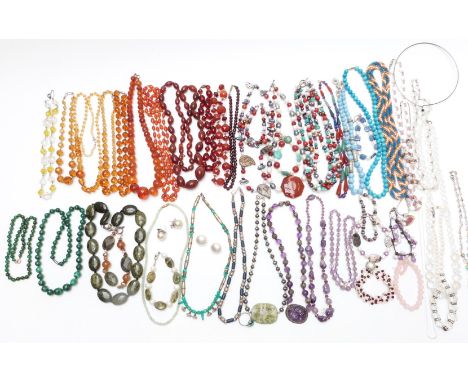 A collection of beaded necklaces including carved amethyst, Chinese carved amethyst with filigree pendant, pearl, Art Deco cr