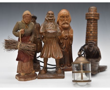 A collection of Bretton carved wood figures together with a novelty wall lamp formed as a lighthouse keeper emerging from the