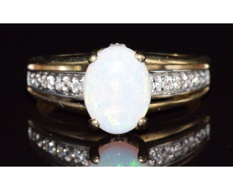 A 9ct gold ring set with an opal cabochon and white sapphires, 2.7g, size N