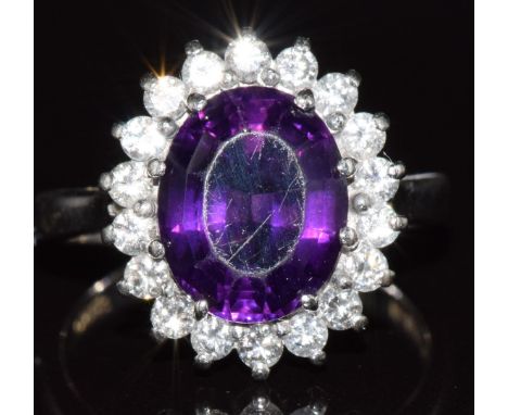 An 18ct white gold ring set with amethyst surrounded by diamonds, 4.8g, size K