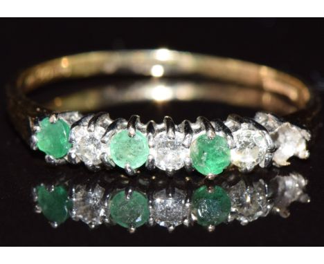 An 18ct gold half eternity ring set with diamonds and emeralds, in vintage box, 2.1g, size S