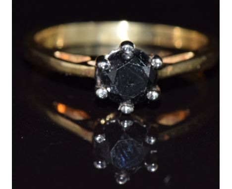 An 18ct gold ring set with a round cut black diamond, 3.7g, size O