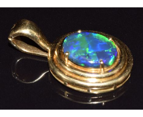 An 18ct gold pendant set with a black opal cabochon of approximately 3.6ct, 9.5g