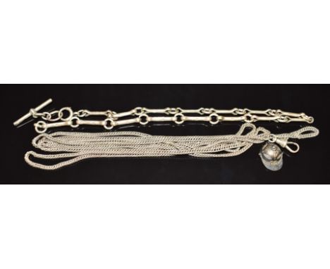 A silver Albert/ watch chain, white metal guard chain, and a silver fob/ charm in the form of a jockey's cap set with a compa