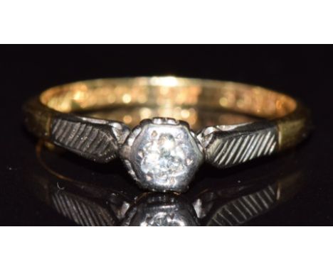 An 18ct gold ring set with a diamond in a platinum setting, 2.1g, size K