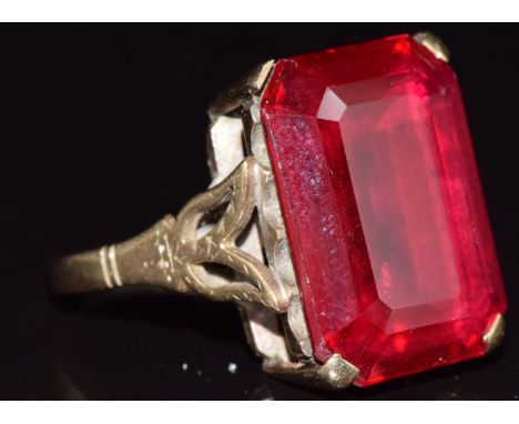 A 9ct gold ring set with an emerald cut synthetic ruby, 7.5g, size O