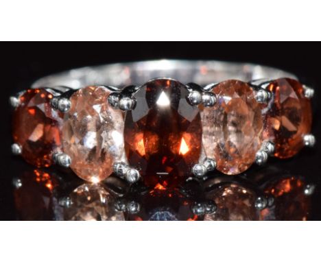 A 9ct white gold ring set with quartz and garnets, 2.4g, size N
