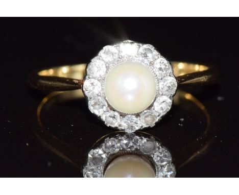 A c1920 18ct gold ring set with a pearl surrounded by diamonds, 2.8g, size O