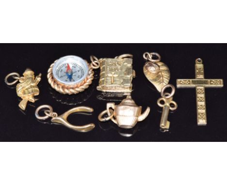 Eight 9ct gold charms/ pendants including compass, bible, cross, ladybird on leaf, key &amp; wishbone, 13.1g