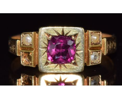 A 15ct gold ring set with a cushion cut garnet and seed pearls, Birmingham 1901, 2.8g, size K