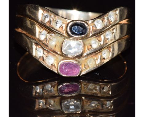 A 14k gold ring set with a ruby, white sapphire and sapphire, 4.1g, size O