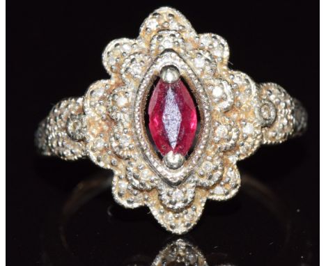 A 9ct white gold ring set with a marquise cut ruby and diamonds, 3.9g, size N