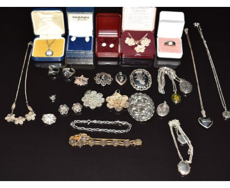 A collection of silver jewellery including Wedgwood pendant, filigree, ring, synthetic opal, Siam silver lockets, brooches an