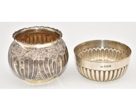 Two hallmarked silver bowls, one Victorian with embossed floral decoration, Birmingham 1890, maker's mark rubbed, the other S