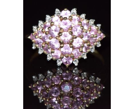 A 9ct gold ring set with pink sapphires and diamonds, 2.7g, size N