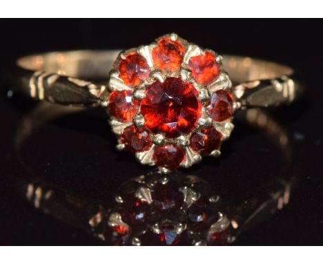 A 9ct gold ring set with garnets in a cluster, 1.9g, size P