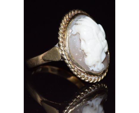 A 22ct gold ring set with a cameo depicting a man, in a 9ct gold surround, 8.3g, size R